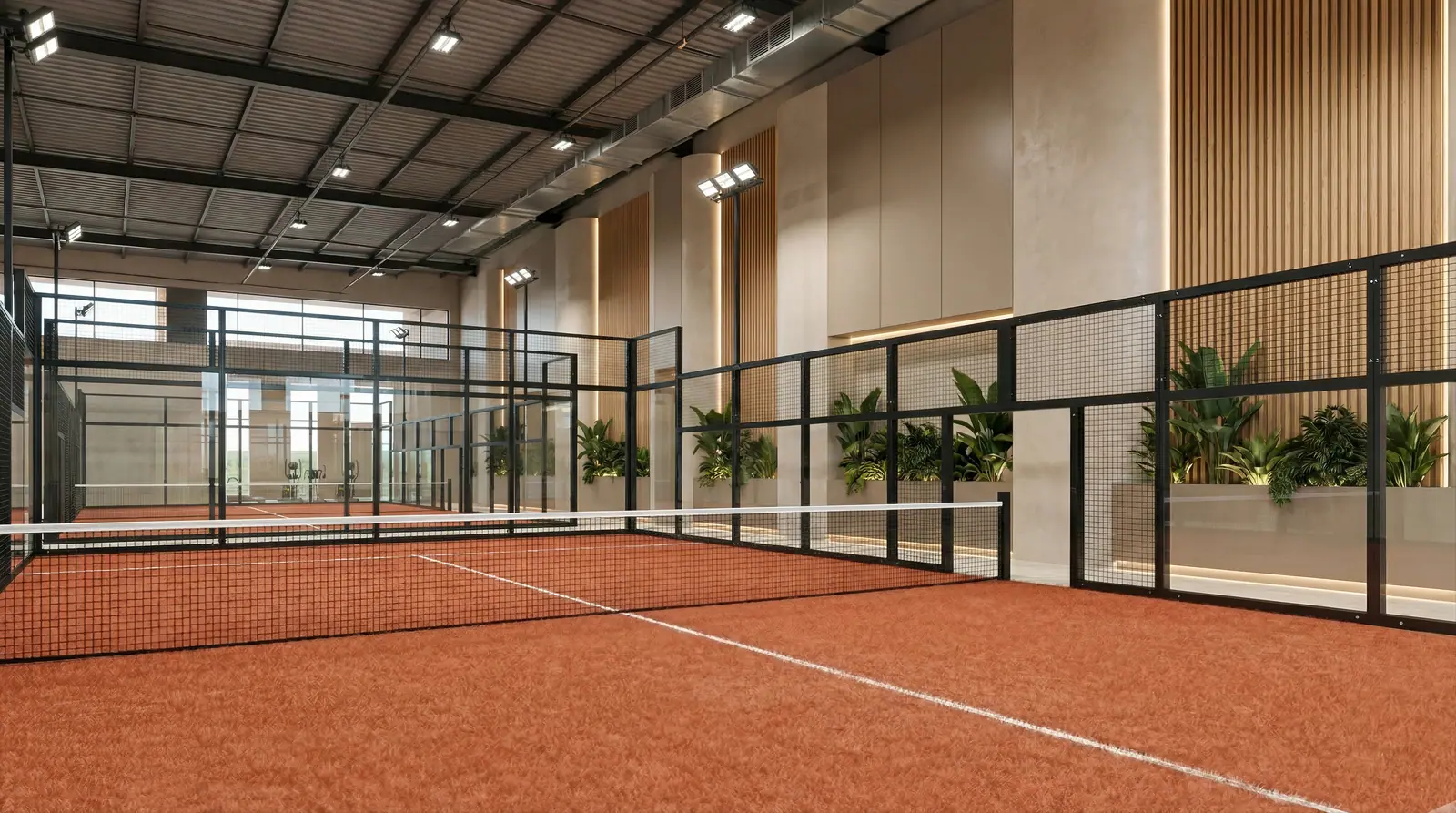 Indoor padel court with clay-red floor, timber slatted walls and a clerestory roof