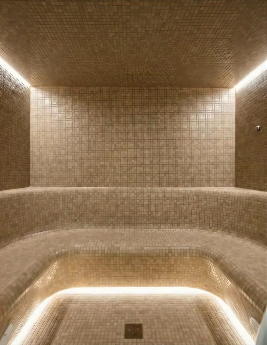 Steam room with mosaic and warm cove lighting