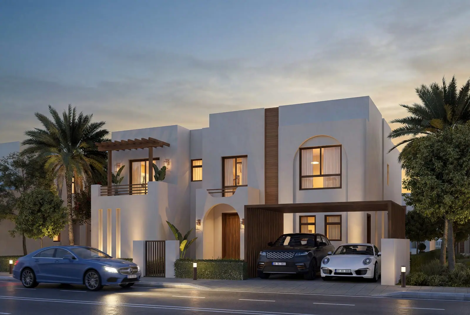 Large villa at dusk with arched windows and timber screens