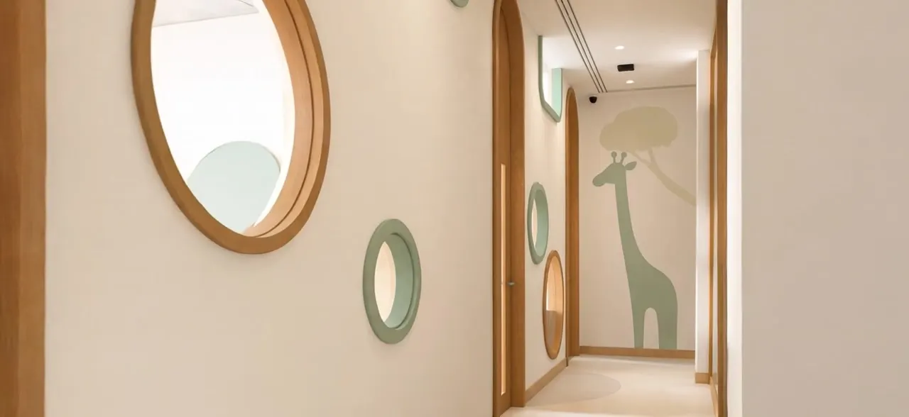 Corridor with ivory walls and oak portholes